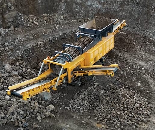 Northrok mobile rock crusher machine, alongside powerful screening machinery, processes and sorts rocks and gravel at a quarry site.