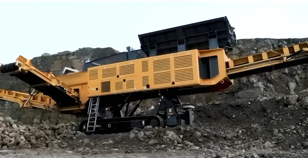 northrok A large yellow mobile industrial crusher sits among rocks at a quarry site, with its conveyor extended and a ladder attached for access, showcasing advanced screening machinery.